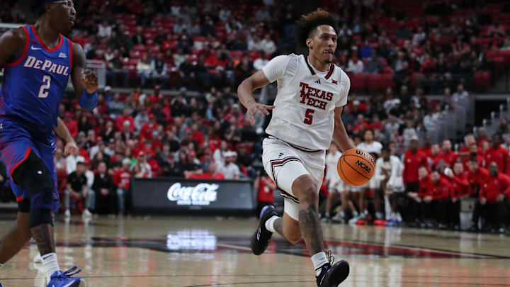 Dec 4, 2024; Lubbock, Texas, USA;  Texas Tech Red Raiders forward Darion Williams (5) drives to the basket against DePaul Blue Demons guard Layden Blocker (2) in the first half at United Supermarkets Arena. Mandatory Credit: Michael C. Johnson-Imagn Images