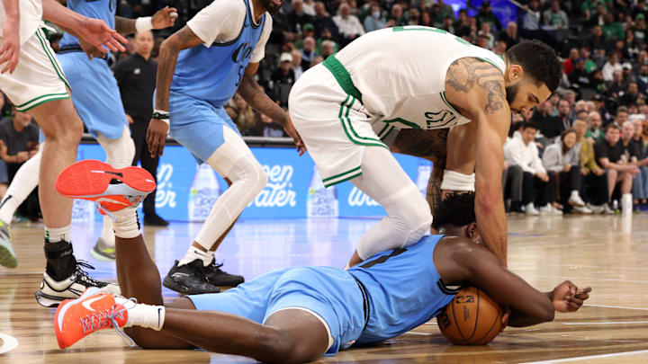 Jan 22, 2025; Inglewood, California, USA; Boston Celtics forward Jayson Tatum (0) and LA Clippers guard Kobe Brown (21) chase a loose ball during the fourth quarter at Intuit Dome. Mandatory Credit: Jason Parkhurst-Imagn Images