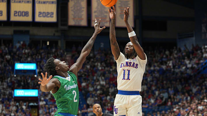 Nov 11, 2025; Lawrence, Kansas, USA; Kansas Jayhawks guard Jamari McDowell (11) shoots against Texas A&M-Corpus Christi Islanders guard Leo Torbor (2) during the first half at Allen Fieldhouse. Mandatory Credit: Jay Biggerstaff-Imagn Images