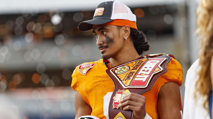 Jan 1, 2024; Orlando, FL, USA; Tennessee Volunteers quarterback Nico Iamaleava (8) poses with the MVP Trophy after defeating the Iowa Hawkeyes at Camping World Stadium. Mandatory Credit: Morgan Tencza-Imagn Images Jan 1, 2024; Orlando, FL, USA; Tennessee Volunteers quarterback Nico Iamaleava (8) poses with the MVP Trophy after defeating the Iowa Hawkeyes at Camping World Stadium. Mandatory Credit: Morgan Tencza-Imagn Images