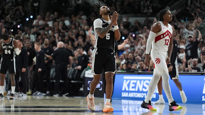 Oct 27, 2025; San Antonio, Texas, USA;  San Antonio Spurs guard Stephon Castle (5) celebrates in front of Toronto Raptors forward Collin Murray-Boyles (12) in the second half at Frost Bank Center. Mandatory Credit: Daniel Dunn-Imagn Images