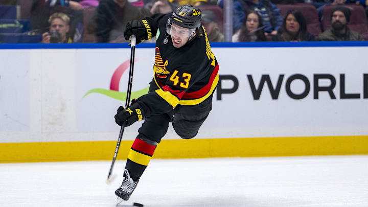Oct 30, 2024; Vancouver, British Columbia, CAN; Vancouver Canucks defenseman Quinn Hughes (43) shoots against the New Jersey Devils during the second period at Rogers Arena. Mandatory Credit: Bob Frid-Imagn Images