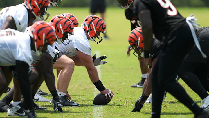 Jun 10, 2025; Cincinnati, OH, USA; Cincinnati Bengals center Ted Karras (64) lines up with the offensive line at the line of scrimmage against the defensive line during practice at Paycor Stadium. Mandatory Credit: Kareem Elgazzar-Imagn Images
