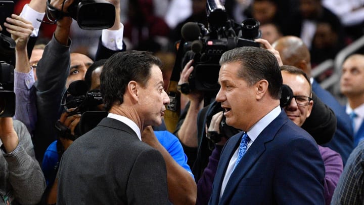 Louisville Cardinals head coach Rick Pitino shakes hands with Kentucky Wildcats head coach John Calipari before the first half at KFC Yum! Center. Louisville defeated Kentucky 73-70. 