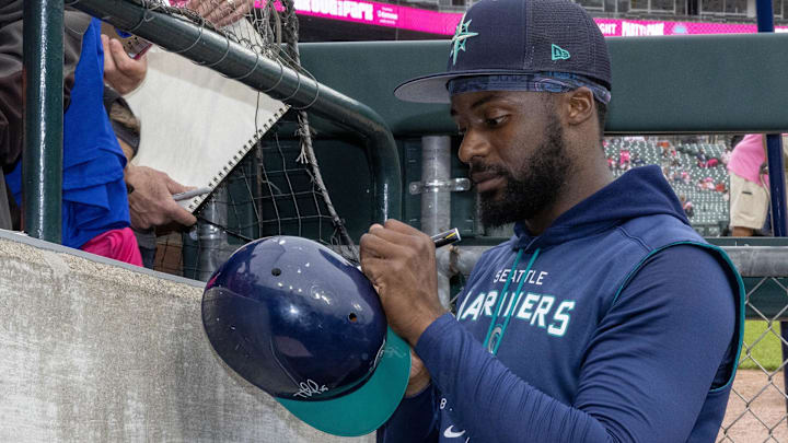 Seattle Mariners right fielder Taylor Trammell (5) signs autographs before a game against the Detroit Tigers at Comerica Park in 2023.