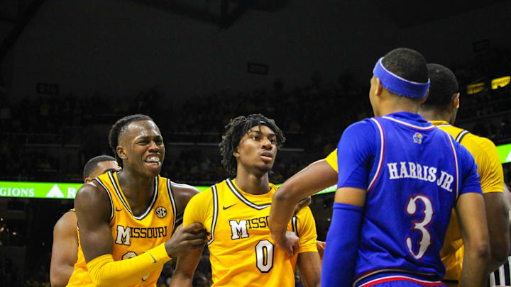 Dec 8, 2024; Columbia, Missouri, USA; Missouri Tigers guard Anthony Robinson (0) is held back by teammates Mark Mitchell (25) and Tamar Bates (2) during a game against the Kansas Jayhawks at Mizzou Arena.