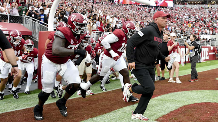 Aug 31, 2024; Tuscaloosa, Alabama, USA;  Alabama Crimson Tide head coach Kalen DeBoer leads his players onto the field at Bryant-Denny Stadium for his first game as head coach. The Crimson Tide played  Western Kentucky Hilltoppers. Mandatory Credit: Gary Cosby Jr.-Imagn Images