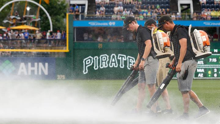 Jun 28, 2025; Pittsburgh, Pennsylvania, USA; The PNC Park grounds crew attempts to blow rain off of the playing surface in order to resume the game against the New York Mets after a rain delay halted play in the second inning at PNC Park. Mandatory Credit: Charles LeClaire-Imagn Images Jun 28, 2025; Pittsburgh, Pennsylvania, USA; The PNC Park grounds crew attempts to blow rain off of the playing surface in order to resume the game against the New York Mets after a rain delay halted play in the second inning at PNC Park. Mandatory Credit: Charles LeClaire-Imagn Images