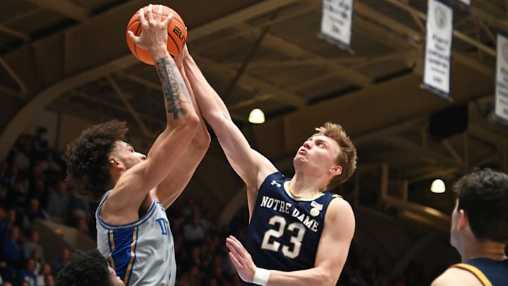 Feb 14, 2023; Durham, North Carolina, USA;  Notre Dame Fighting Irish guard Dane Goodwin (23) blocks a pass by Duke Blue Devils center Dereck Lively (1) during the second half at Cameron Indoor Stadium.  The Blue Devils won 68-64. Mandatory Credit: Rob Kinnan-Imagn Images