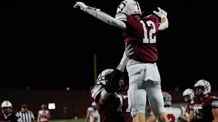 Dowling Catholic wide receiver Beau Gamble  (12) is thrown into the air by offensive lineman George Nahas (77) during the game at Valley Stadium in Valley Junction on Friday, Sept. 16, 2022. The Maroons are up at the half against the Little Hawks, 21-0.