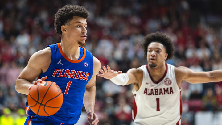 Mar 5, 2025; Tuscaloosa, Alabama, USA; Florida Gators guard Walter Clayton Jr. (1) drives the ball against Alabama Crimson Tide guard Mark Sears (1) during the first half at Coleman Coliseum.
