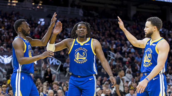 Jan 4, 2024; San Francisco, California, USA; Golden State Warriors forward Andrew Wiggins (22) and guard Kevon Looney (5) and guard Stephen Curry (30) react after drawing a foul against the Denver Nuggets during the first half at Chase Center. Mandatory Credit: John Hefti-Imagn Images