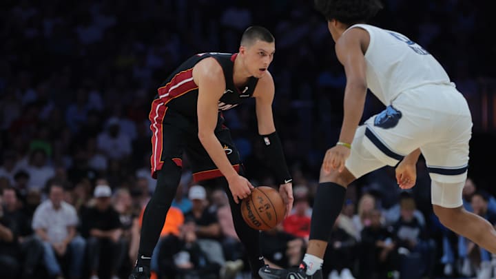Apr 3, 2025; Miami, Florida, USA; Miami Heat guard Tyler Herro (14) dribbles the basketball as Memphis Grizzlies forward Jaylen Wells (0) defends during the third quarter at Kaseya Center. Mandatory Credit: Sam Navarro-Imagn Images