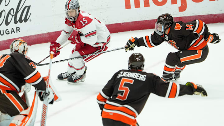 Jan. 6, 2024; Columbus, Ohio, USA; 
Cam Thiesing (15) of Ohio State is defended by Bowling Green goalkeeper Cole Moore (34), Gustav Stjernberg (5) and Dalton Norris (15) during a hockey game against on Friday night at Value City Arena.