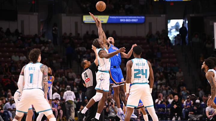 Oct 5, 2025; North Charleston, South Carolina, USA; Oklahoma City Thunder forward Jaylin Williams (6) tips off against Charlotte Hornets forward Miles Bridges (0) at North Charleston Coliseum. Mandatory Credit: Arthur Ellis-Imagn Images