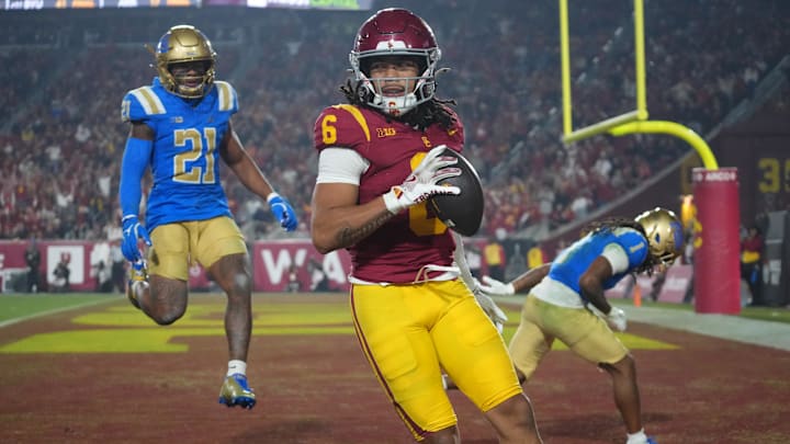 Southern California Trojans wide receiver Makai Lemon (6) catches a 32-yard touchdown pass against UCLA Bruins defensive back Kanye Clark (1) in the second half at United Airlines Field at Los Angeles Memorial Coliseum. Mandatory Credit: Kirby Lee-Imagn Images Southern California Trojans wide receiver Makai Lemon (6) catches a 32-yard touchdown pass against UCLA Bruins defensive back Kanye Clark (1) in the second half at United Airlines Field at Los Angeles Memorial Coliseum. Mandatory Credit: Kirby Lee-Imagn Images