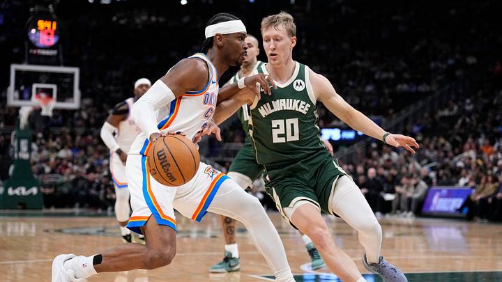 Jan 21, 2026; Milwaukee, Wisconsin, USA; Oklahoma City Thunder guard Shai Gilgeous-Alexander (2) drives to the basket against Milwaukee Bucks guard AJ Green (20) in the first half at Fiserv Forum. Mandatory Credit: Michael McLoone-Imagn Images