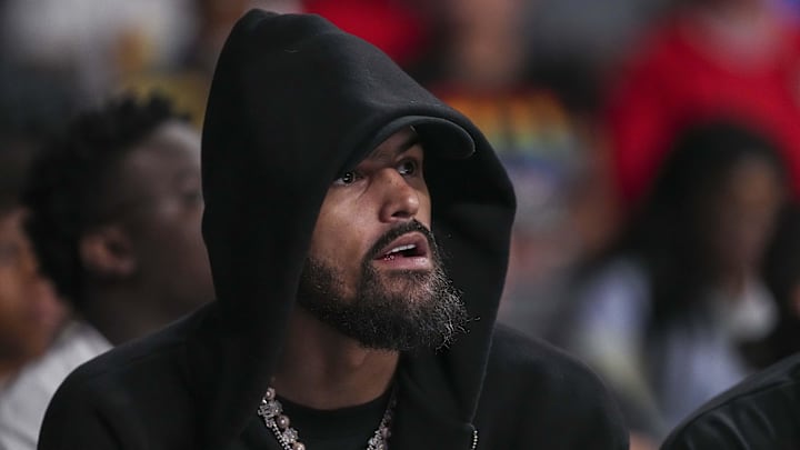 Atlanta Hawks player Trae Young watches the game between the Atlanta Dream against the Minnesota Lynx during the first half at Gateway Center Arena at College Park.