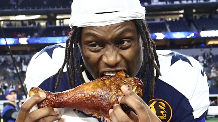 Dallas Cowboys wide receiver George Pickens celebrates by eating turkey after the game against the Kansas City Chiefs 