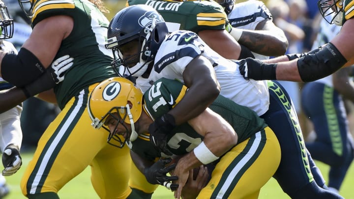 Sep 10, 2017; Green Bay, WI, USA;  Seattle Seahawks defensive end Cliff Avril (56) sacks Green Bay Packers quarterback Aaron Rodgers (12) in the first quarter at Lambeau Field. Mandatory Credit: Benny Sieu-USA TODAY Sports