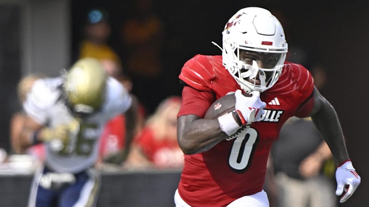 Sep 21, 2024; Louisville, Kentucky, USA; Louisville Cardinals wide receiver Chris Bell (0) runs the ball against the Georgia Tech Yellow Jackets during the first half at L&N Federal Credit Union Stadium. Sep 21, 2024; Louisville, Kentucky, USA; Louisville Cardinals wide receiver Chris Bell (0) runs the ball against the Georgia Tech Yellow Jackets during the first half at L&N Federal Credit Union Stadium.