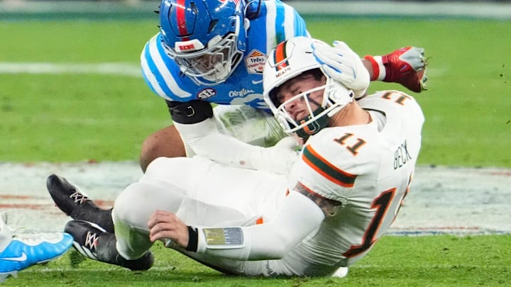 Mississippi Rebels linebacker TJ Dottery (6) tackles Miami Hurricanes quarterback Carson Beck (11)