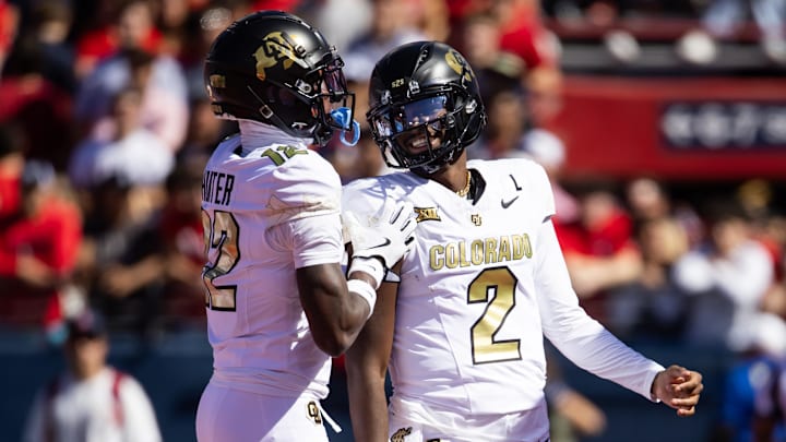 Oct 19, 2024; Tucson, Arizona, USA; Colorado Buffalos quarterback Shedeur Sanders (2) with wide receiver Travis Hunter (12) against the Arizona Wildcats at Arizona Stadium. Mandatory Credit: Mark J. Rebilas-Imagn Images Oct 19, 2024; Tucson, Arizona, USA; Colorado Buffalos quarterback Shedeur Sanders (2) with wide receiver Travis Hunter (12) against the Arizona Wildcats at Arizona Stadium. Mandatory Credit: Mark J. Rebilas-Imagn Images