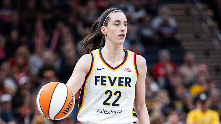Jul 9, 2025; Indianapolis, Indiana, USA; Indiana Fever guard Caitlin Clark (22) dibbles in the first half against Golden State Valkyries at Gainbridge Fieldhouse. Mandatory Credit: Trevor Ruszkowski-Imagn Images