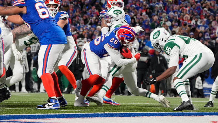 Jan 4, 2026; Orchard Park, New York, USA; Buffalo Bills running back Ty Johnson (26) carries the ball for a touchdown defended by New York Jets safety Keidron Smith (46) during the fourth quarter at Highmark Stadium