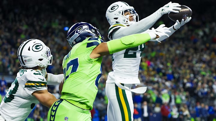 Dec 15, 2024; Seattle, Washington, USA; Green Bay Packers cornerback Carrington Valentine (24) intercepts a pass against Seattle Seahawks tight end Noah Fant (87) during the second quarter at Lumen Field. Mandatory Credit: Joe Nicholson-Imagn Images