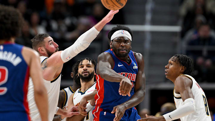 Feb 3, 2026; Detroit, Michigan, USA;  Detroit Pistons forward Isaiah Stewart (28) passes the ball to teammate Cade Cunningham (2) while being defended by Denver Nuggets center Jonas Valanciunas (17) in the fourth quarter at Little Caesars Arena. Mandatory Credit: Lon Horwedel-Imagn Images