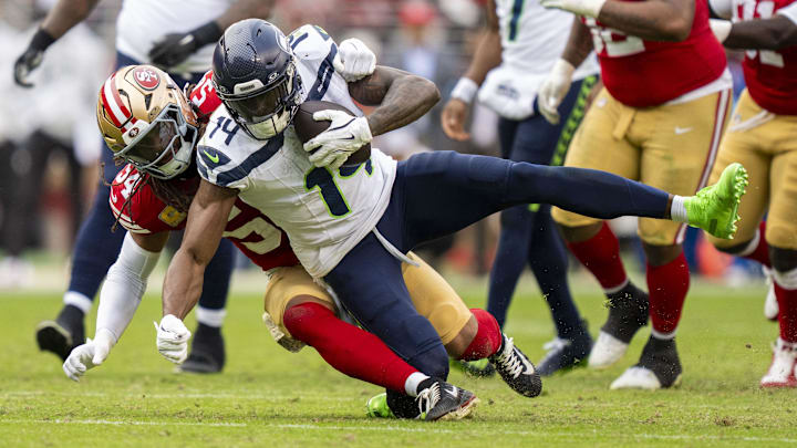 November 17, 2024; Santa Clara, California, USA; Seattle Seahawks wide receiver DK Metcalf (14) is tackled by San Francisco 49ers linebacker Fred Warner (54) 