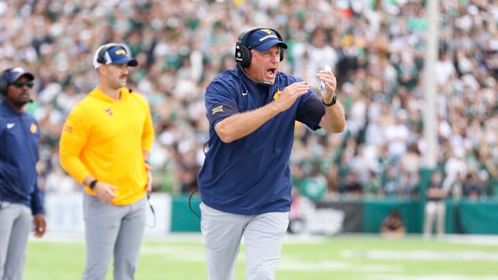 Sep 6, 2025; Athens, Ohio, USA; West Virginia Mountaineers head coach Rich Rodriguez calls a timeout during the second quarter against the Ohio Bobcats at Peden Stadium. Mandatory Credit: Ben Queen-Imagn Images