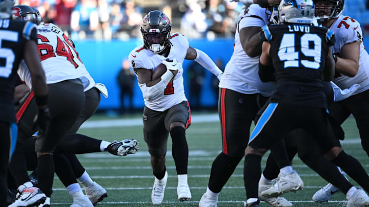 Jan 7, 2024; Charlotte, North Carolina, USA; Tampa Bay Buccaneers running back Rachaad White (1) runs in the fourth quarter at Bank of America Stadium. Mandatory Credit: Bob Donnan-Imagn Images Jan 7, 2024; Charlotte, North Carolina, USA; Tampa Bay Buccaneers running back Rachaad White (1) runs in the fourth quarter at Bank of America Stadium. Mandatory Credit: Bob Donnan-Imagn Images