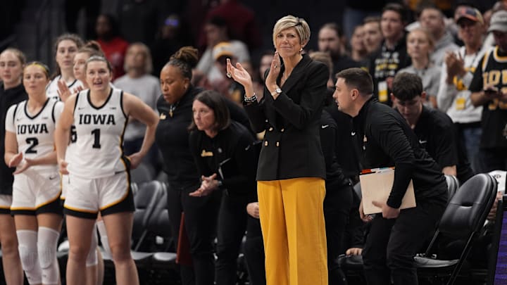Nov 10, 2024; Charlotte, NC, USA; Iowa Hawkeyes head coach Jan Jensen applauds her teams win during the second half against the Virginia Tech Hokies at Spectrum Center. Mandatory Credit: Jim Dedmon-Imagn Images