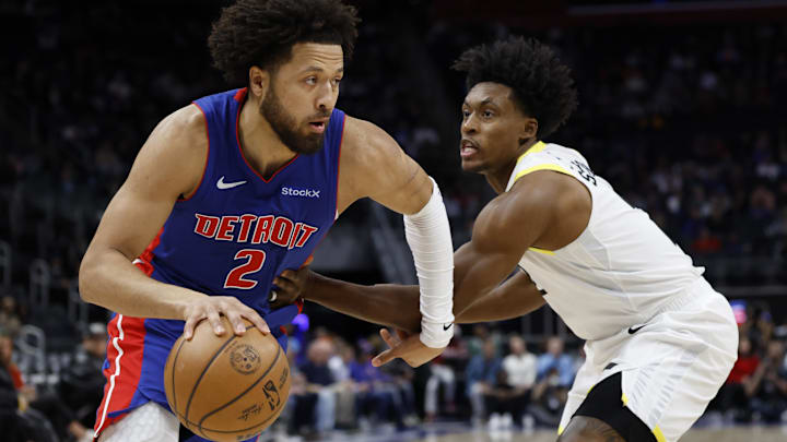 Detroit Pistons guard Cade Cunningham (2) dribbles on Utah Jazz guard Collin Sexton (2) in the first half at Little Caesars Arena.