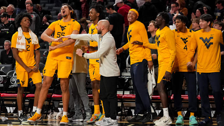 Feb 5, 2026; Cincinnati, Ohio, USA;  Members of the West Virginia Mountaineers celebrate on the bench against the Cincinnati Bearcats in the second half at Fifth Third Arena. Mandatory Credit: Aaron Doster-Imagn Images
