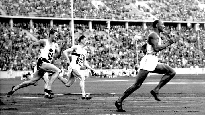 Jesse Owens (right) smokes competitors in the 200-meter sprint at the Berlin Summer Games, setting a new Olympic record.