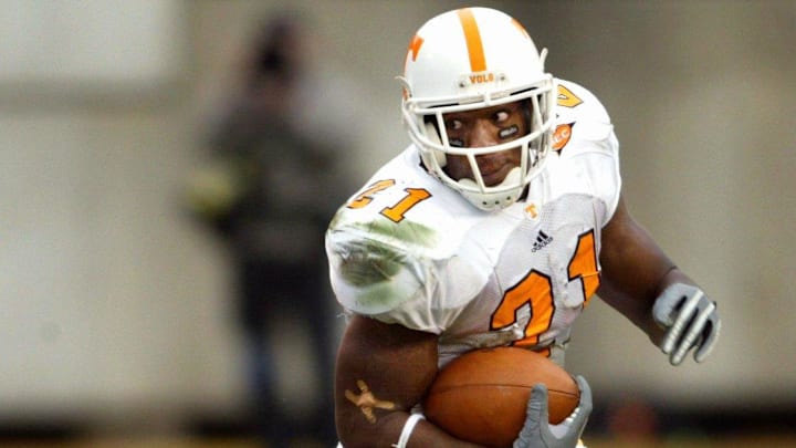 Tennessee running back Cedric Houston (21) eludes Vanderbilt defender Theo Horrocks (54) on one of his 19 carries for total of 97 yards. The 15th-ranked Vols held off Vandy 38-33 for the win at Dudley Field in Nashville on Nov. 20, 2004. Tennessee running back Cedric Houston (21) eludes Vanderbilt defender Theo Horrocks (54) on one of his 19 carries for total of 97 yards. The 15th-ranked Vols held off Vandy 38-33 for the win at Dudley Field in Nashville on Nov. 20, 2004.