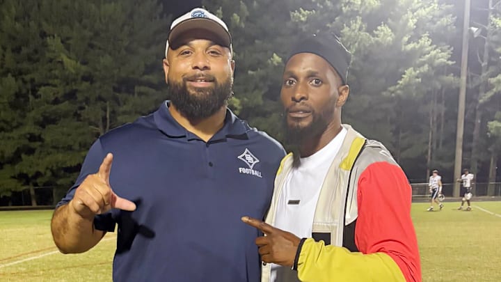Stone Bridge (Va.) head coach Kedric Golston (left) and Tanard Jackson, the parent of a Quince Orchard player, were NFL teammates with the 2012 Washington Redskins.