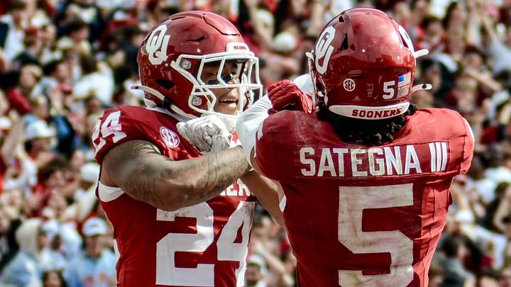 Oklahoma running back Xavier Robinson celebrates a touchdown with receiver Isaiah Sategna. Oklahoma running back Xavier Robinson celebrates a touchdown with receiver Isaiah Sategna.