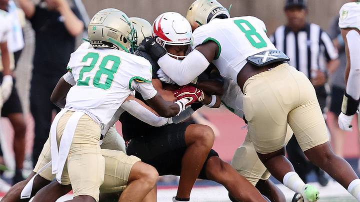 The Buford defense gang tackles Milton running back TJ Lester. The Buford defense gang tackles Milton running back TJ Lester.