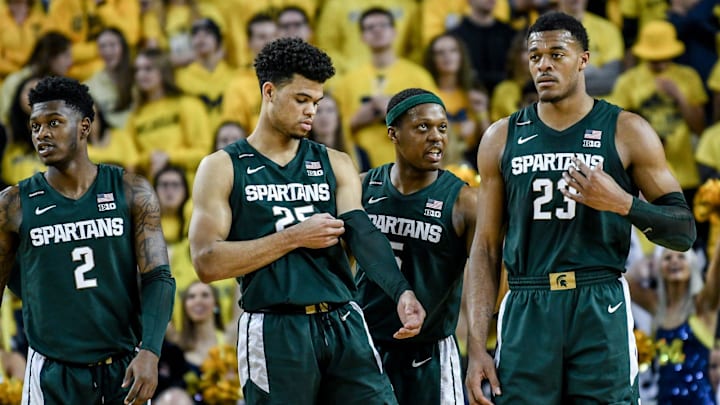 Michigan State's Cassius Winston, center, talks with Xavier Tillman, right, as teammates Rocket Watts, left, and Malik Hall look on during the first half on Saturday, Feb. 8, 2020, at the Crisler Center in Ann Arbor.

200208 Msu Um 057a
