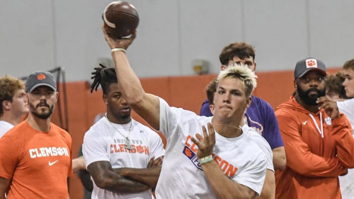 Tait Reynolds, Class of 2026 Pro style quarterback from Queen Creek, Arizona passes near Clemson offensive coordinator Garrett Riley, left, during the 2024 Dabo Swinney Football Camp in Clemson in Clemson June 5, 2024.