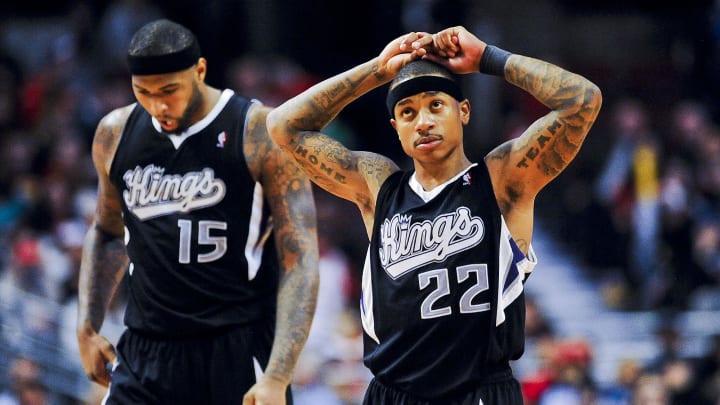 Mar 15, 2014; Chicago, IL, USA; Sacramento Kings center DeMarcus Cousins (15) looks down after he fouled Chicago Bulls forward Mike Dunleavy (not pictured) as Kings guard Isaiah Thomas (22) reacts in the second half of their game against the Bulls at the United Center. The Bulls won 94-87.  Mandatory Credit: Matt Marton-USA TODAY Sports