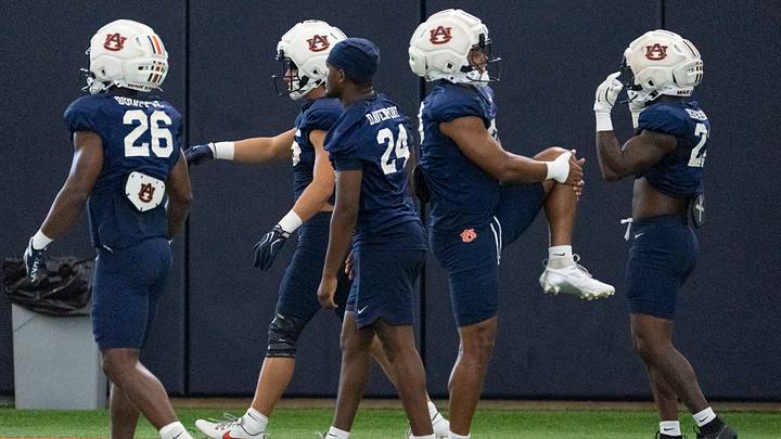 Auburn Tigers running backs warm up during Auburn football practice at Woltosz Football Performance Center in Auburn, Ala. on Tuesday, Aug. 18, 2026.