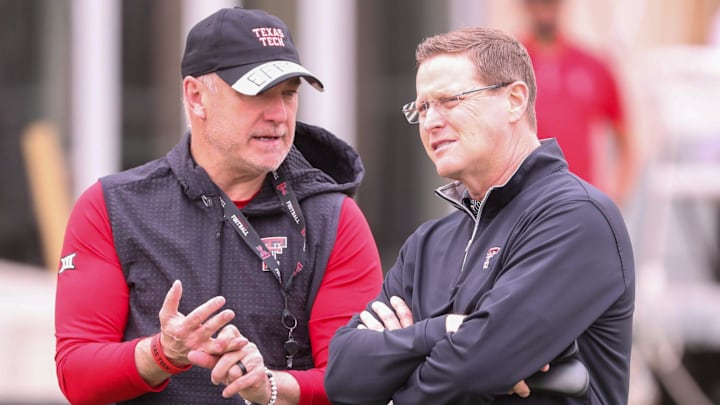 Texas Tech director of athletics Kirby Hocutt (right) speaks with Joey McGuire during spring practice, Tuesday, April 1, 2025, at the Womble Football Center.