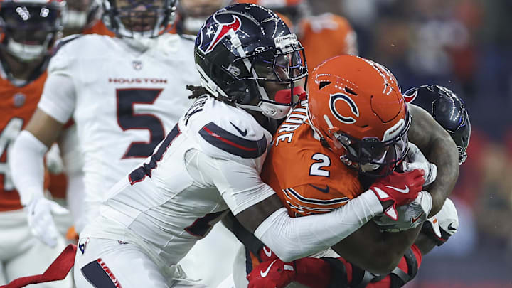 Sep 15, 2024; Houston, Texas, USA; Houston Texans safety Calen Bullock (21) attempts to tackle Chicago Bears wide receiver DJ Moore (2) during the game at NRG Stadium. Mandatory Credit: Troy Taormina-Imagn Images