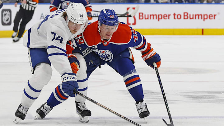 Feb 3, 2026; Edmonton, Alberta, CAN; Toronto Maple Leafs forward Bobby McMann (74) and Edmonton Oilers defensemen Ty Emberson (49) chases a loose puck during the second period at Rogers Place. Mandatory Credit: Perry Nelson-Imagn Images