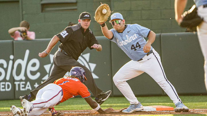 Clemson outfielder Bryce Clavon (1) dives back to first under the tag of University of North Carolina junior Erik Paulsen (44) during the bottom of the third inning at Doug Kingsmore Stadium in Clemson, S.C. Friday, April 10, 2026.